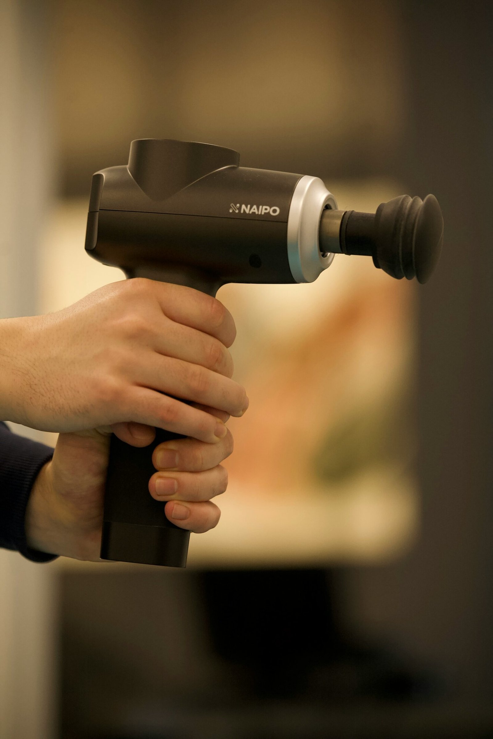 person holding black and gray cordless hand drill